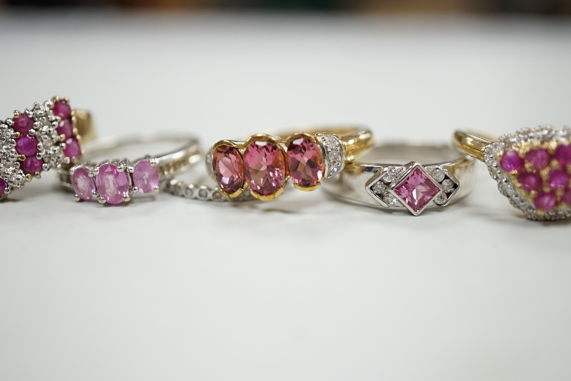 Five assorted modern 9ct gold and gem set dress rings, gross weight 16.7 grams and one other white metal and gem set eternity ring.
